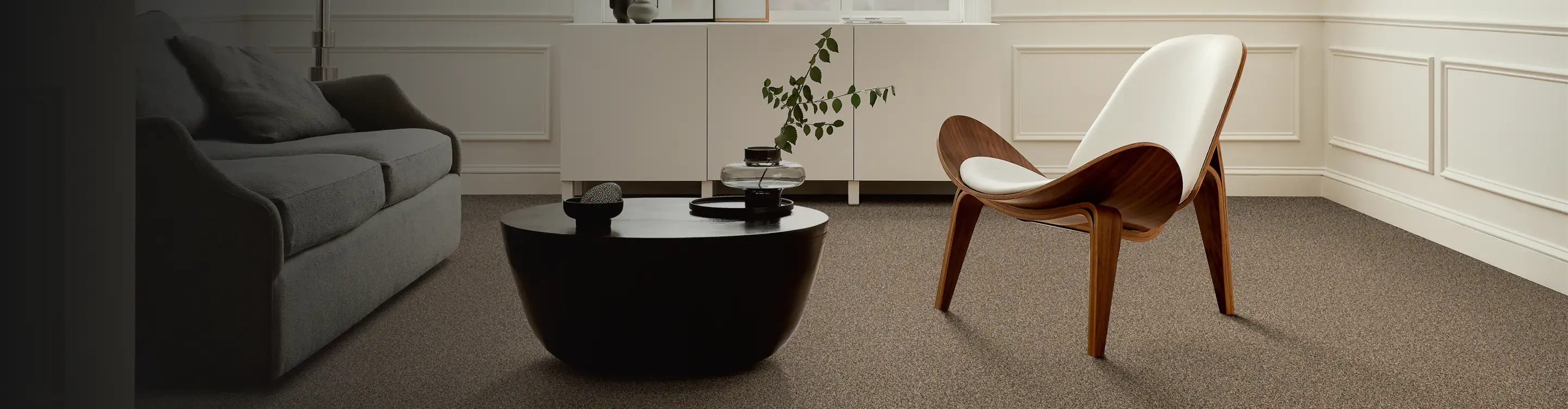 beige carpet in a sitting area with a wooden accent chair